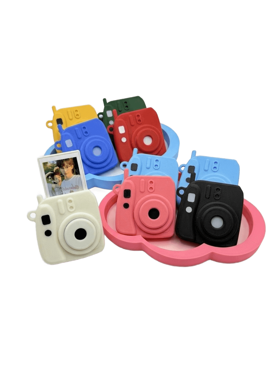 A rainbow of mini camera charms made by the studio